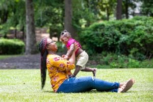 Terri lifting Aubrielle, her daughter, in the air. 