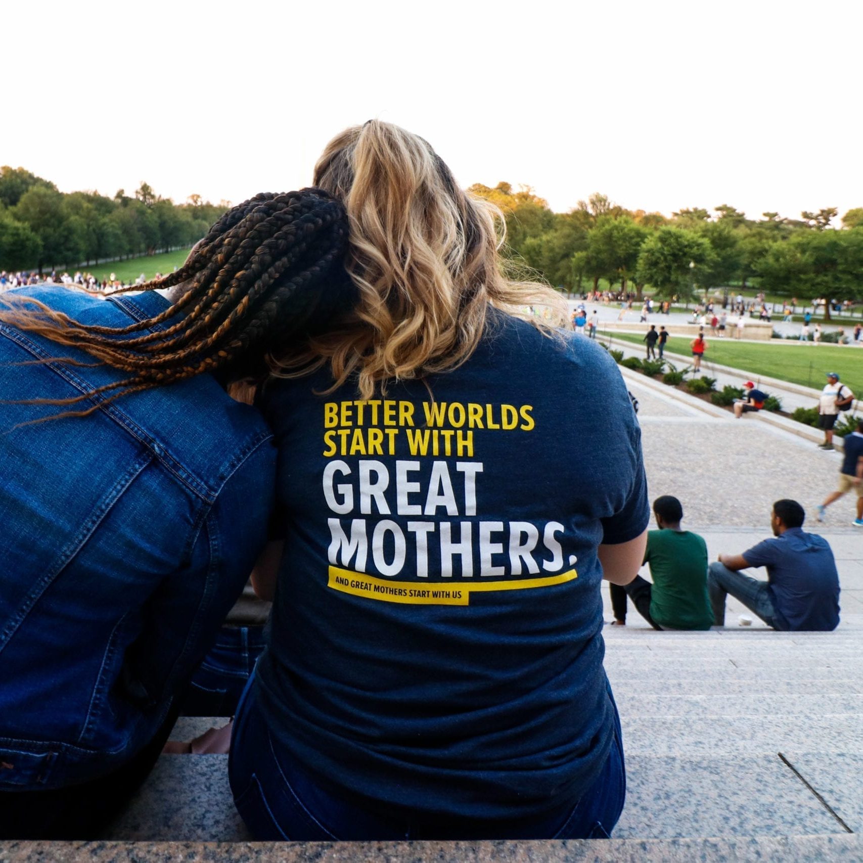 Parent Ambassadors Gayle and Allison soaking in the environment around them while sitting at the steps of the Lincoln Memorial at the Parent Ambassador social event outing