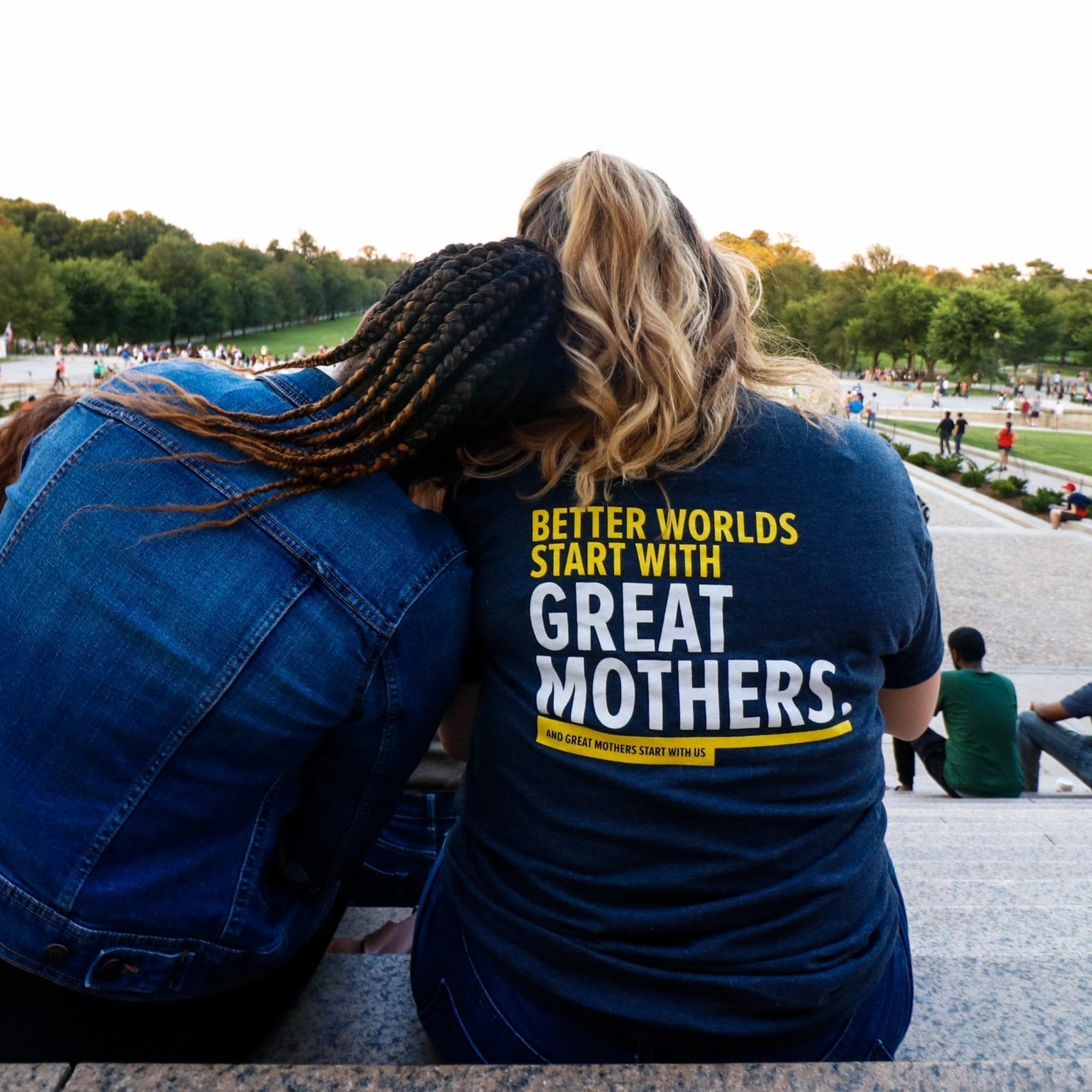 Parent Ambassadors Gayle and Allison soaking in the environment around them while sitting at the steps of the Lincoln Memorial at the Parent Ambassador social event outing